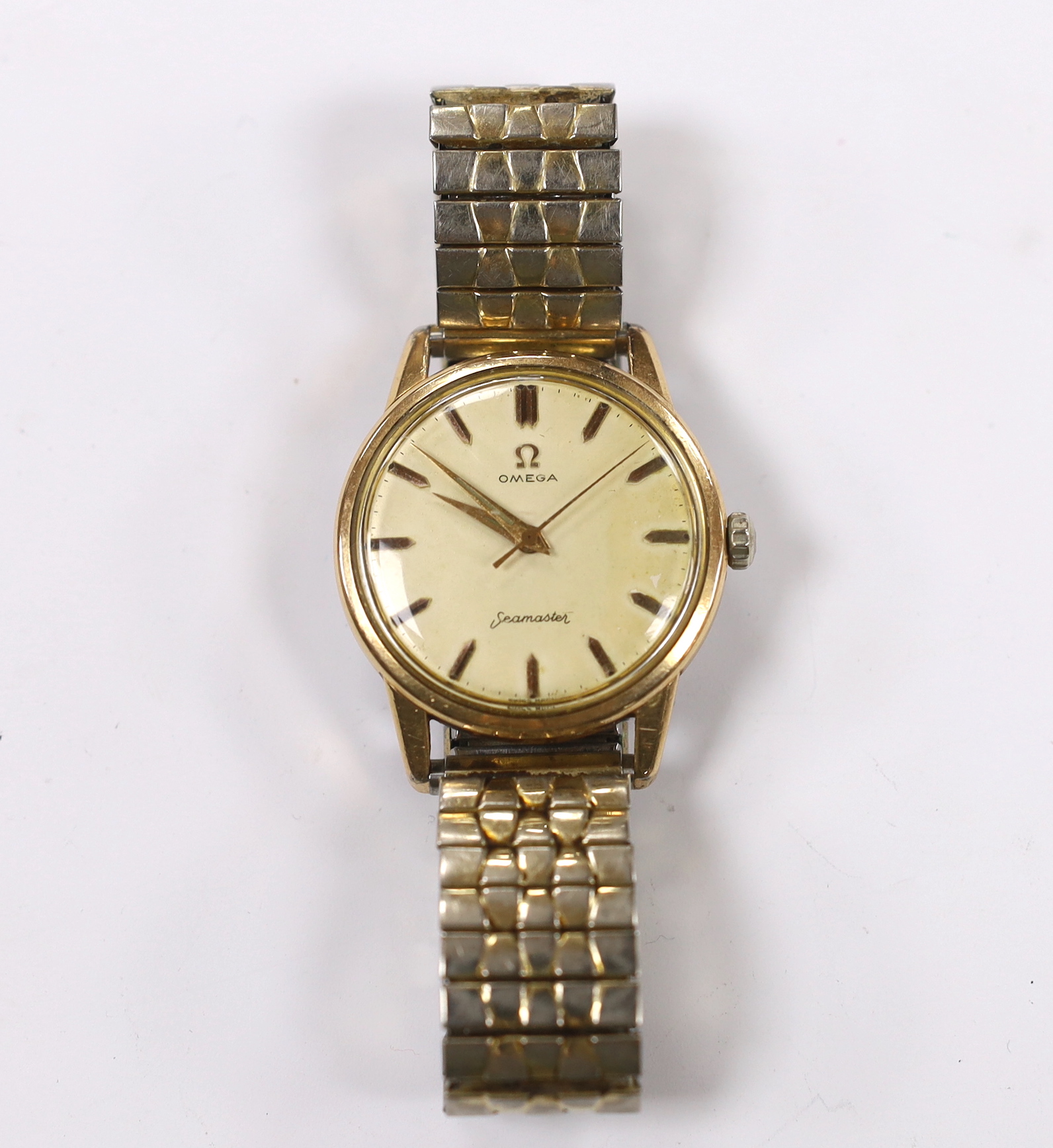 A gentleman's steel and gold plated Omega Seamaster manual wind wrist watch, cased diameter 35mm, on a later associated flexible bracelet.
